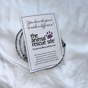 Silver wraparound bracelet with stones and purple paw prints.